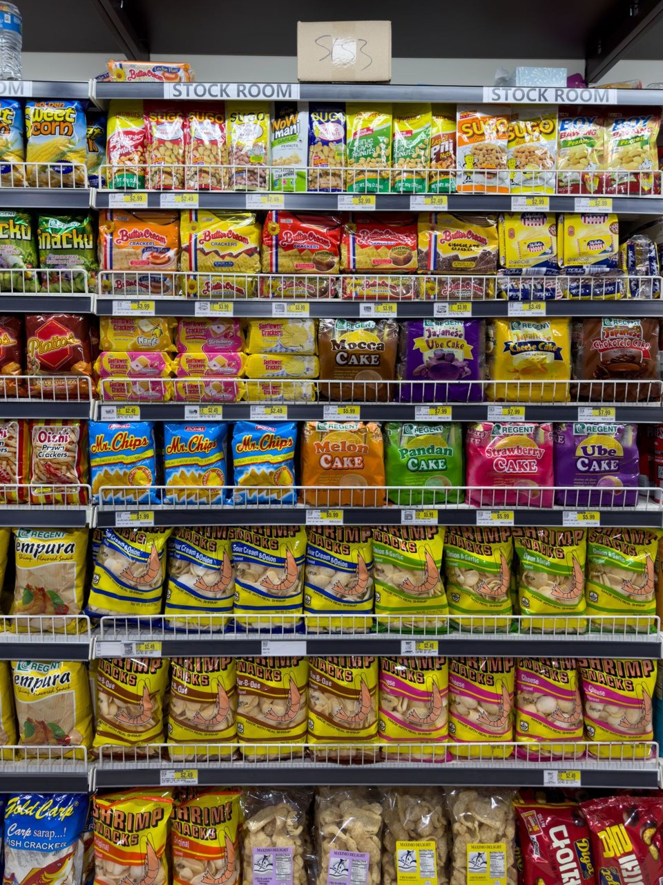 Free Variety of snacks in an indoor supermarket aisle, colorful packaging. Stock Photo